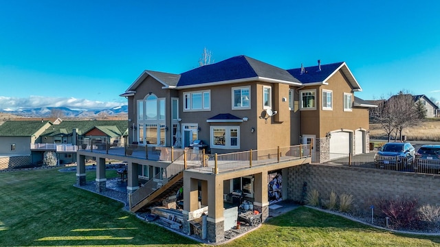 4428 Fox View Loop, Helena, MT 59602 - back of property with stucco siding, an attached garage, stairway, a wooden deck, and a yard