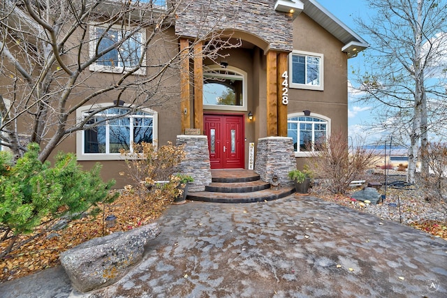 4428 Fox View Loop, Helena, MT 59602 - doorway to property featuring stucco siding and stone siding