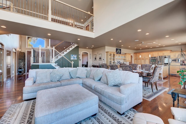 4428 Fox View Loop, Helena, MT 59602 - living area with a towering ceiling, wood finished floors, stairway, recessed lighting, and arched walkways