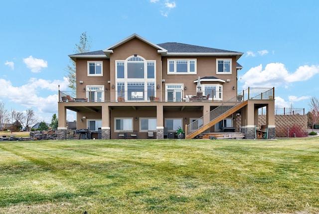 4428 Fox View Loop, Helena, MT 59602 - rear view of house featuring stucco siding, stairs, a lawn, and stone siding