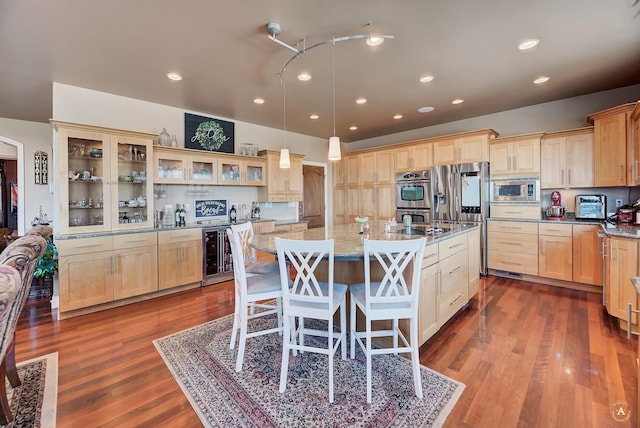 4428 Fox View Loop, Helena, MT 59602 - kitchen with appliances with stainless steel finishes, wine cooler, light brown cabinetry, recessed lighting, and a center island with sink