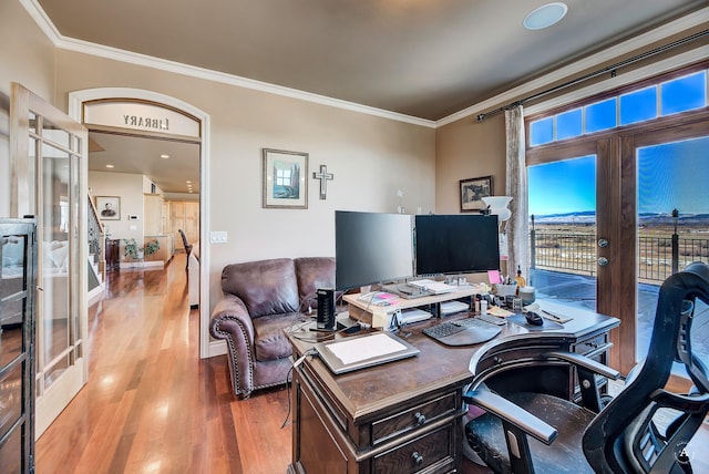 office with french doors, ornamental molding, and wood-type flooring