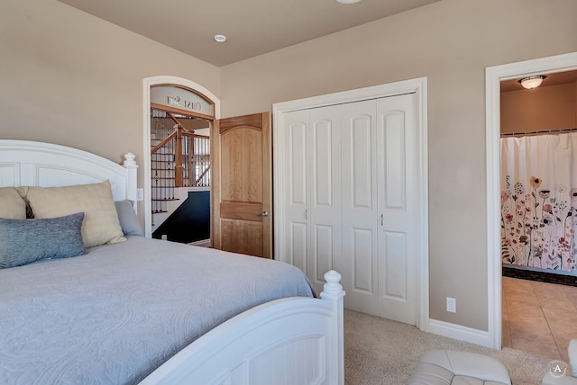 bedroom with light colored carpet and a closet