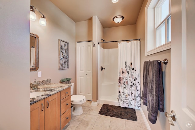 bathroom featuring vanity, a shower with shower curtain, tile patterned floors, and toilet