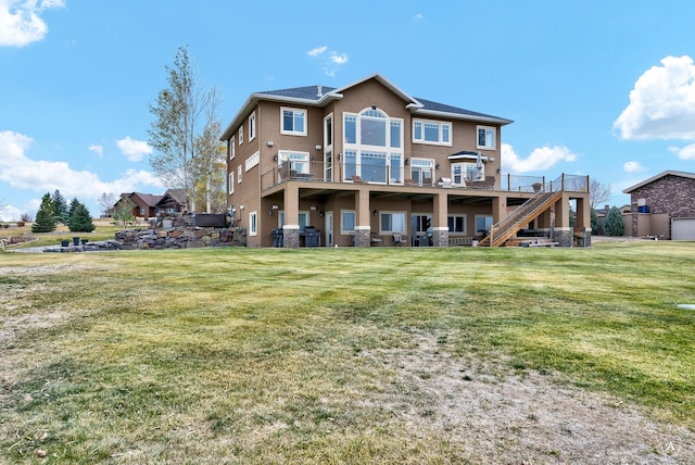 4428 Fox View Loop, Helena, MT 59602 - back of property with stucco siding, stairway, a lawn, and a deck