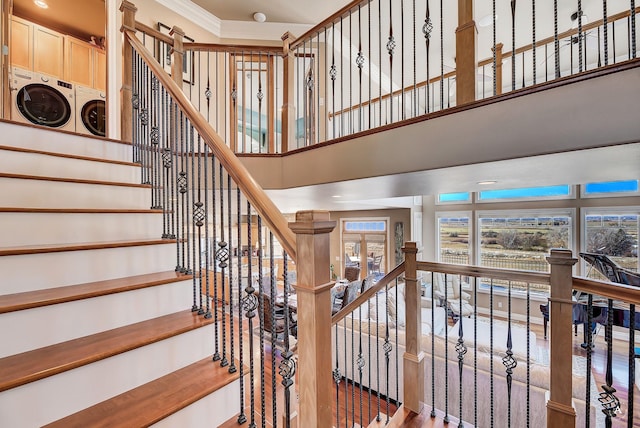 4428 Fox View Loop, Helena, MT 59602 - staircase with washer and clothes dryer, ornamental molding, and a towering ceiling