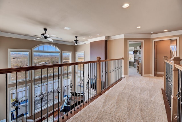 corridor featuring ornamental molding and light colored carpet