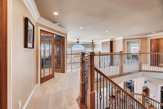 hall featuring crown molding and light carpet