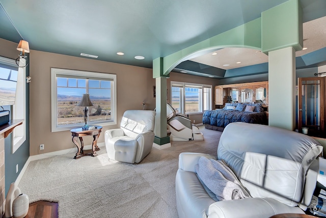 bedroom featuring light colored carpet and ornate columns