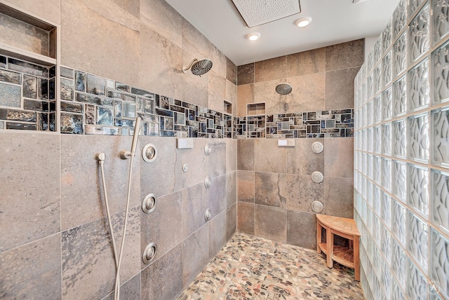 bathroom with a tile shower