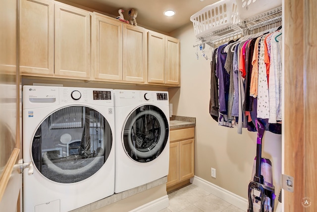 washroom with cabinets, independent washer and dryer, and light tile patterned flooring