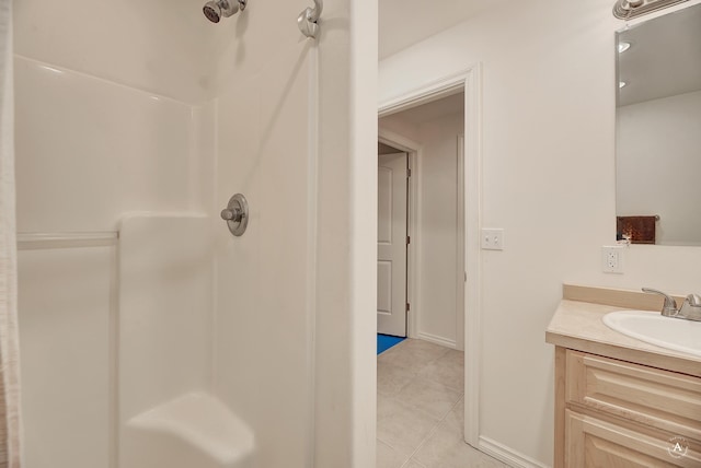 bathroom featuring vanity, tile patterned floors, and walk in shower