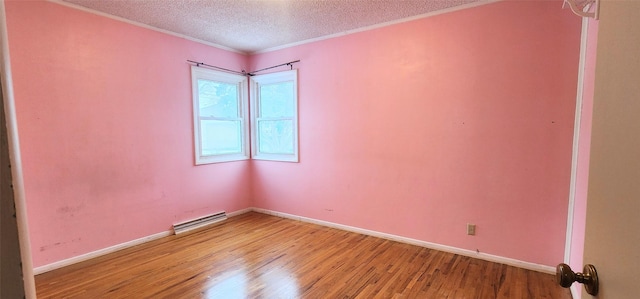 unfurnished room with crown molding, light hardwood / wood-style floors, and a textured ceiling