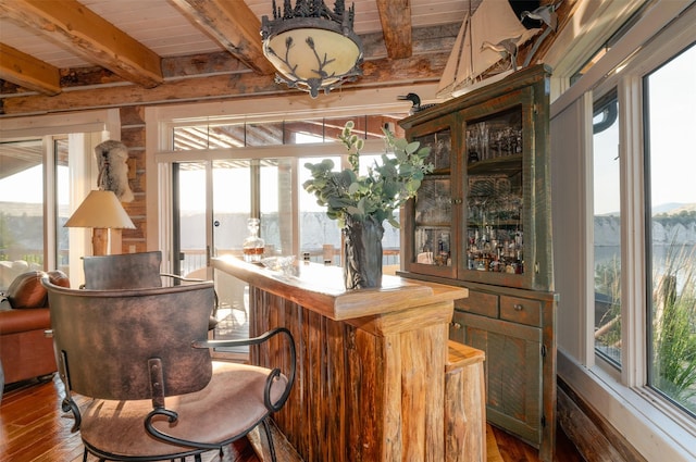 bar with wood-type flooring, beam ceiling, and wooden ceiling