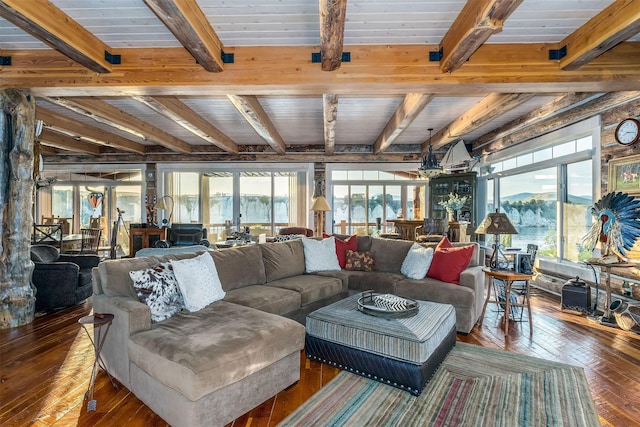 living room with beamed ceiling, a healthy amount of sunlight, and dark hardwood / wood-style flooring