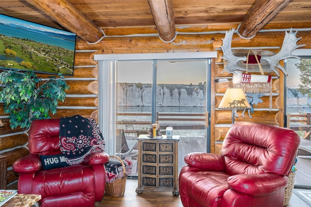 sitting room featuring hardwood / wood-style floors, beam ceiling, and wooden ceiling