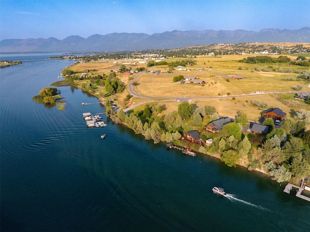 aerial view featuring a water and mountain view