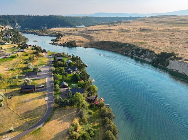 drone / aerial view featuring a water and mountain view