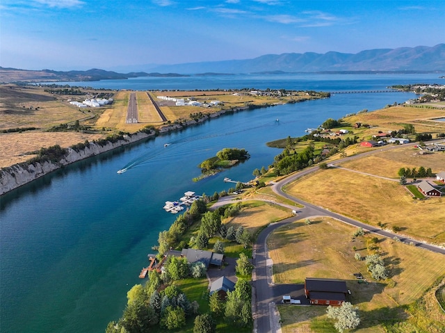 birds eye view of property with a water and mountain view