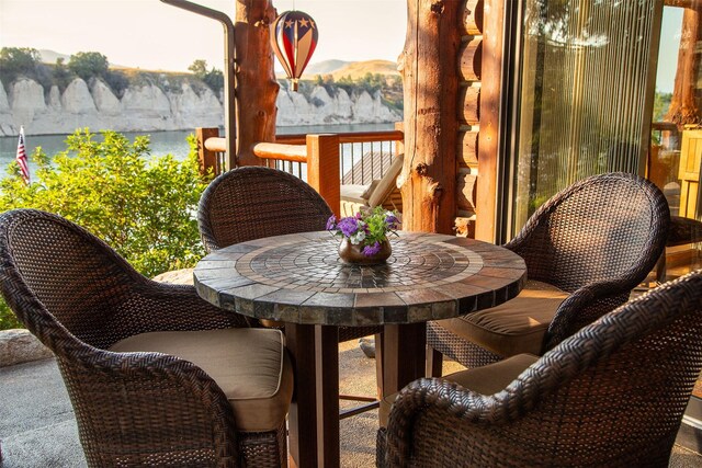 rear view of property with a yard, outdoor lounge area, and a deck with mountain view