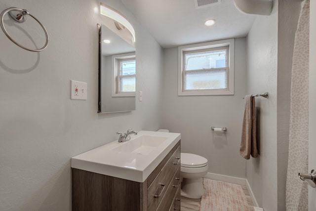 bathroom with vanity and toilet