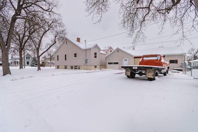 view of front facade with a garage and an outbuilding