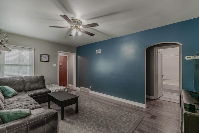 living room with hardwood / wood-style flooring and ceiling fan