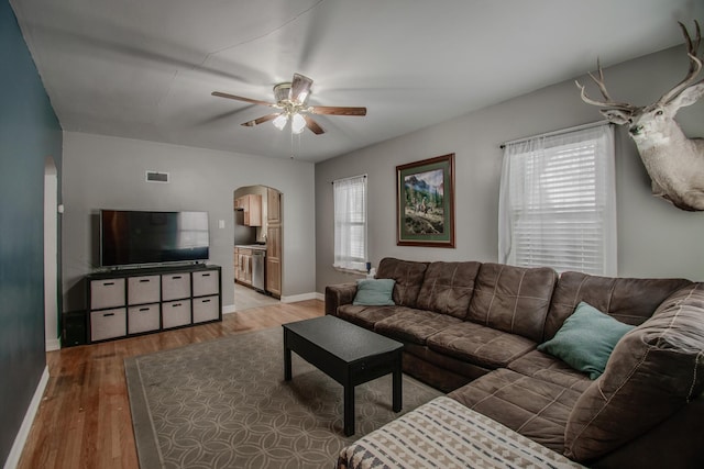 living room featuring hardwood / wood-style flooring, ceiling fan, and a wealth of natural light