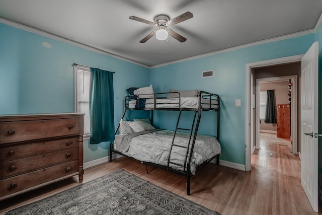 bedroom featuring ornamental molding, ceiling fan, and light wood-type flooring