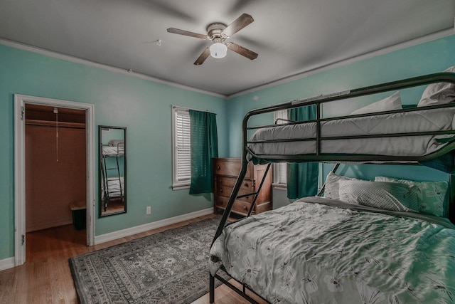 bedroom with crown molding, ceiling fan, and hardwood / wood-style flooring