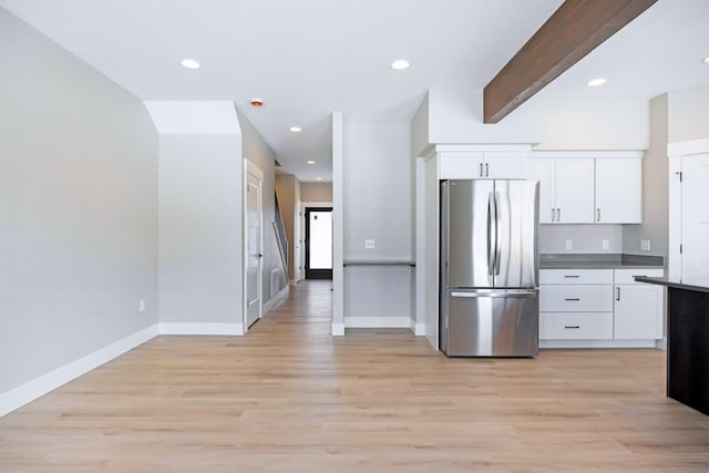 kitchen featuring stainless steel refrigerator, white cabinets, and light wood-type flooring