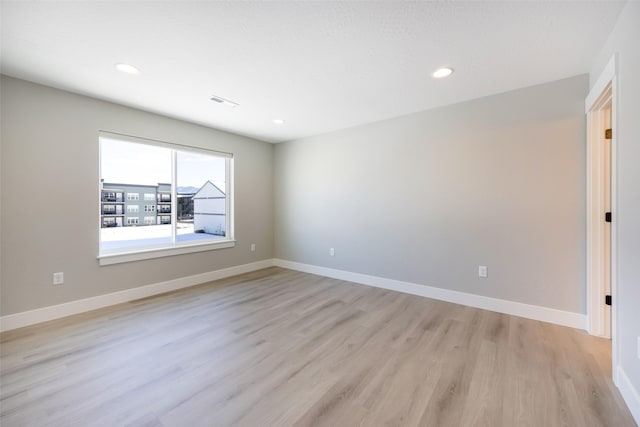 empty room with light hardwood / wood-style floors