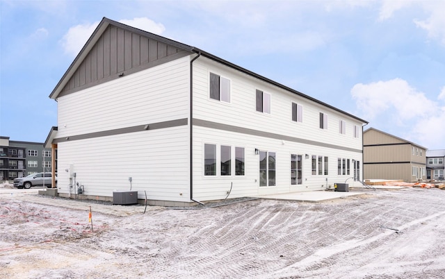 back of house featuring central AC unit and a patio area