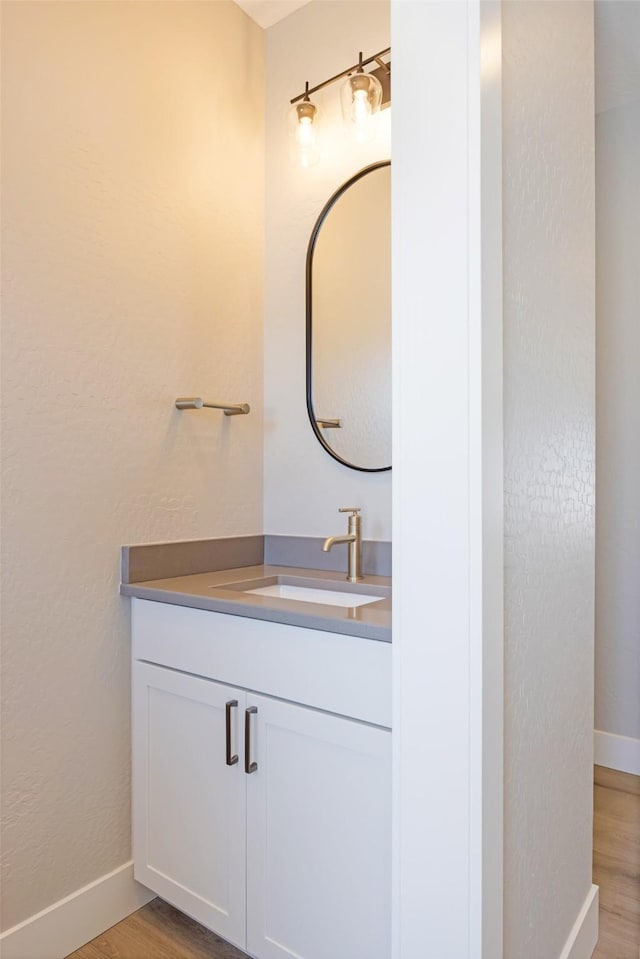 bathroom featuring vanity and hardwood / wood-style flooring