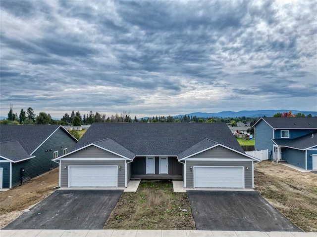 view of front facade featuring a garage and a mountain view