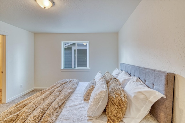 carpeted bedroom with a textured ceiling