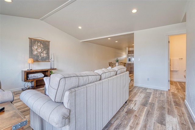 living room featuring light hardwood / wood-style flooring and vaulted ceiling