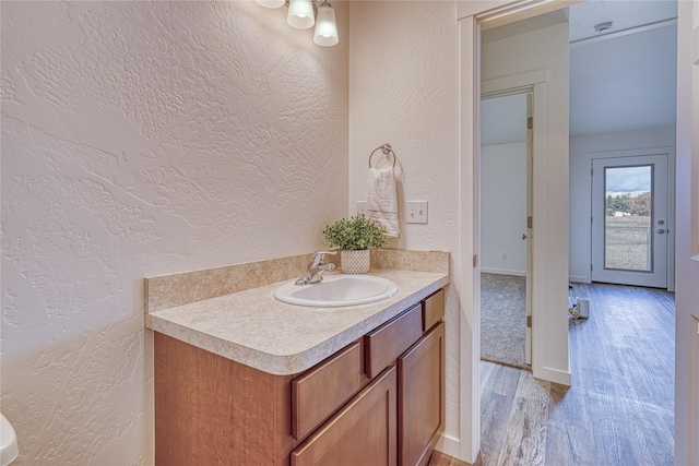 bathroom featuring vanity and hardwood / wood-style flooring