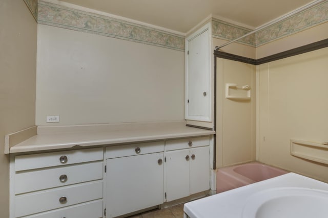 bathroom featuring sink,  shower combination, and tile patterned floors