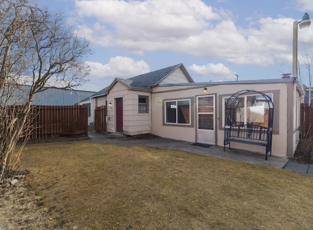 rear view of property with a yard