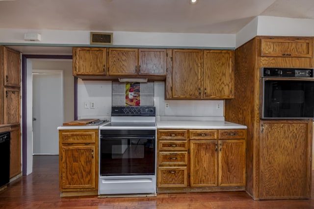 kitchen featuring tasteful backsplash, hardwood / wood-style floors, and black appliances