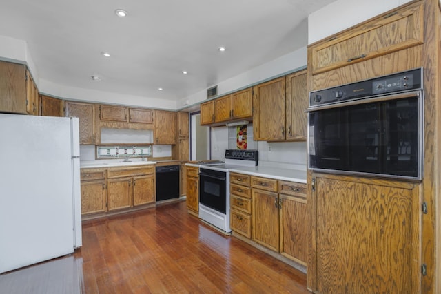 kitchen with sink, black appliances, and dark hardwood / wood-style floors