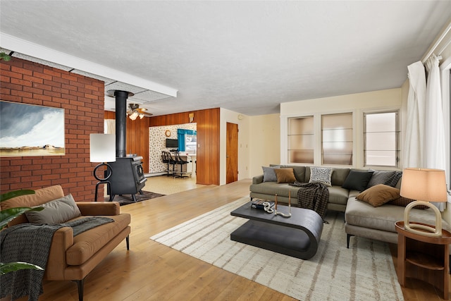 living room featuring a wood stove and light hardwood / wood-style flooring