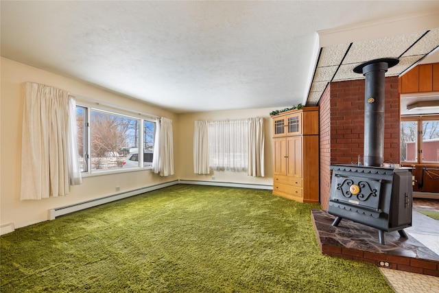 unfurnished living room featuring plenty of natural light, a wood stove, and a textured ceiling