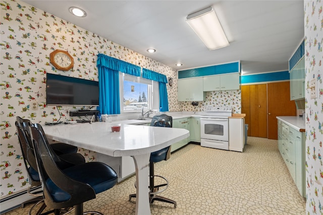 kitchen featuring a baseboard heating unit, kitchen peninsula, a kitchen breakfast bar, and white range with electric cooktop