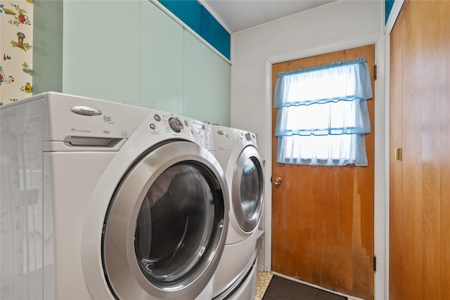 clothes washing area featuring independent washer and dryer and a healthy amount of sunlight