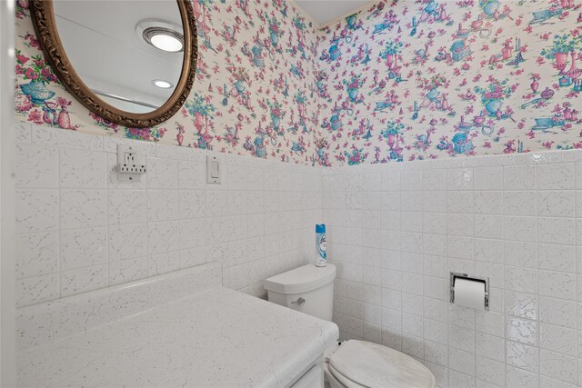 bathroom featuring a baseboard radiator, vanity, and a shower with shower door