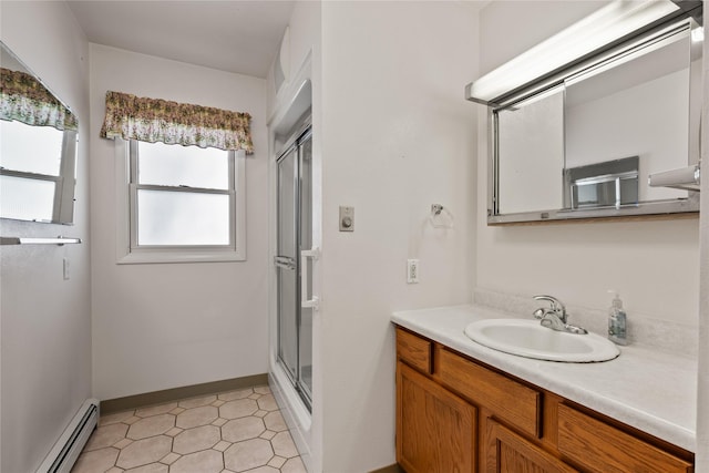 bathroom featuring an enclosed shower, vanity, and baseboard heating