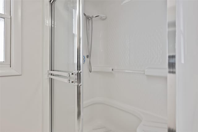 bathroom with a shower with shower door