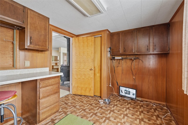 kitchen with light parquet flooring and wood walls